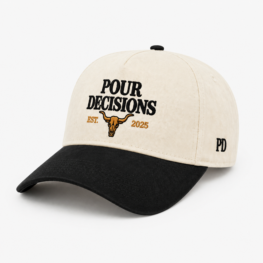 Pour Decisions SnapBack, cream five-panel crown with black curved brim and embroidered gold badge