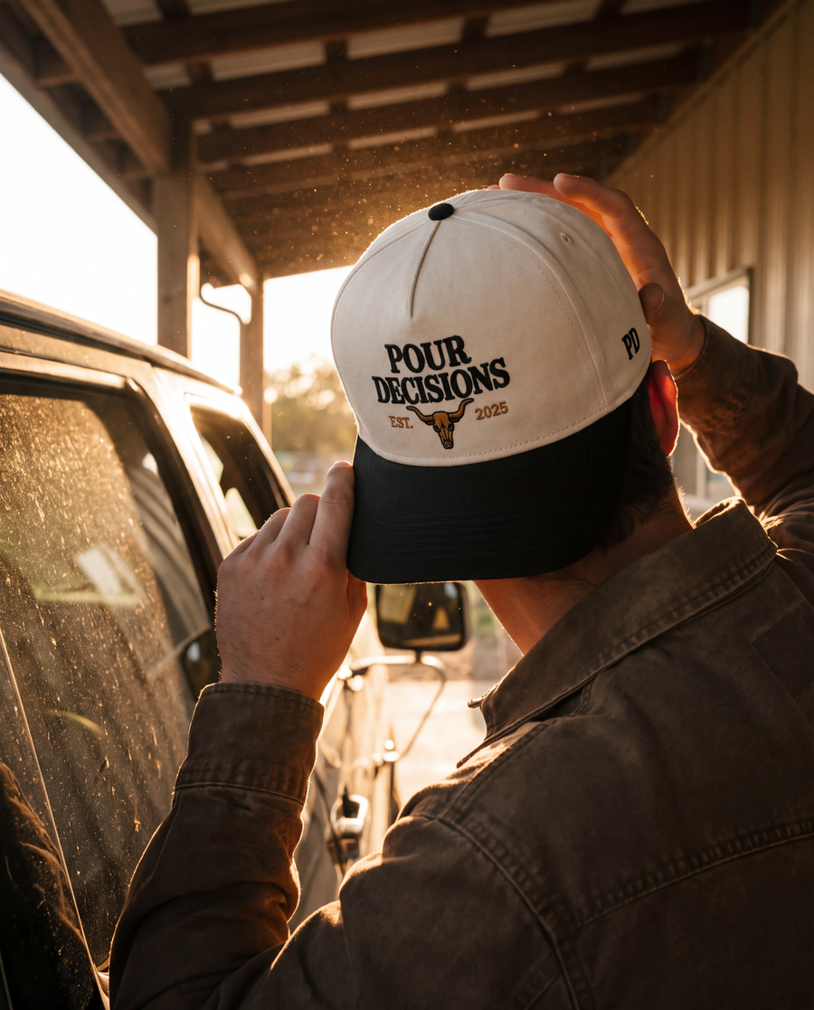 Pour Decisions SnapBack in cream and black, worn