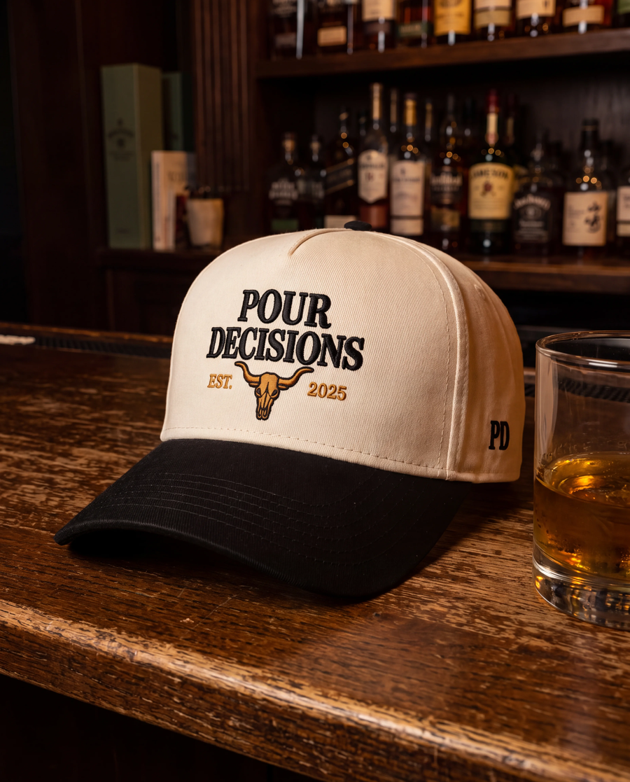 Pour Decisions SnapBack being worn, cream five-panel crown with black curved brim