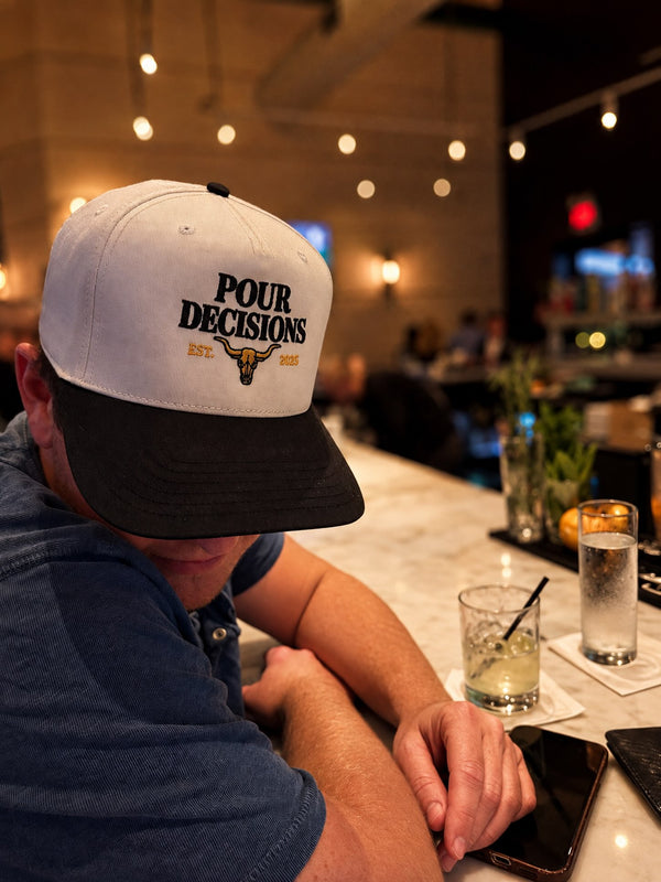 Pour Decisions SnapBack at the bar, head down, drink in hand