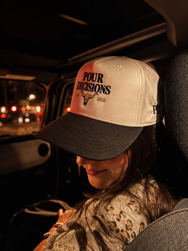 Pour Decisions SnapBack in the passenger seat under red lights
